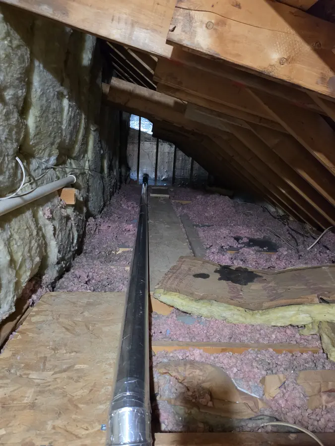 After: Rigid metal duct running straight through the same attic