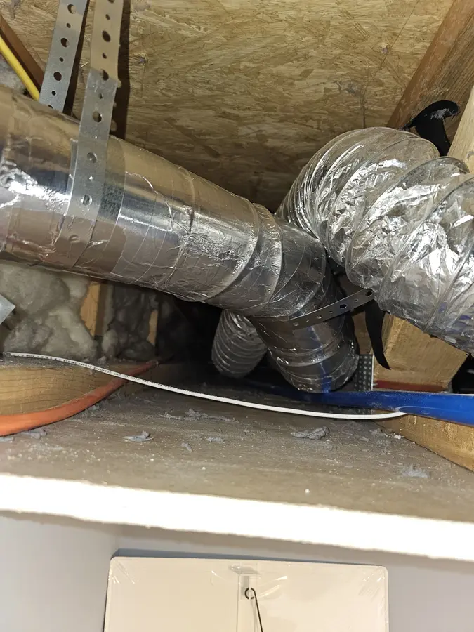 After: Supported duct run properly routed between the joists