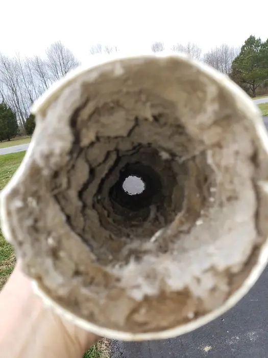 A vent pipe almost closed off with lint