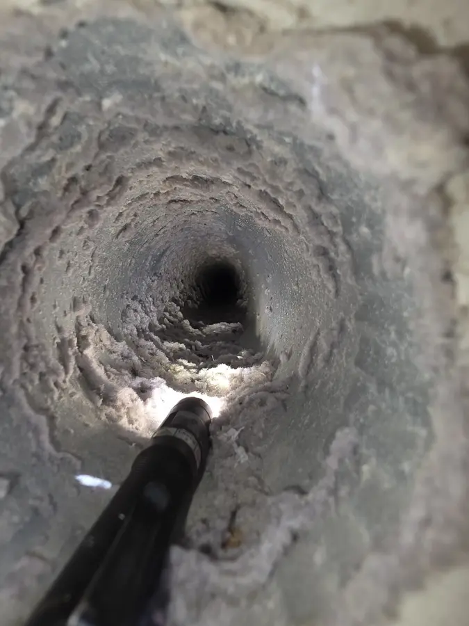 Before: Inside of a dryer duct coated with thick lint